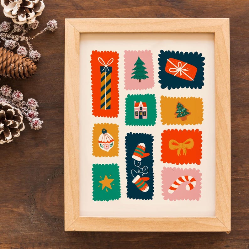 May include: A framed art print featuring a grid of colorful, scalloped-edge rectangles, each containing a holiday-themed illustration including a gift, a pine tree, a house, a gingerbread tree, an ornament, mittens, a bow, a star, and a candy cane.