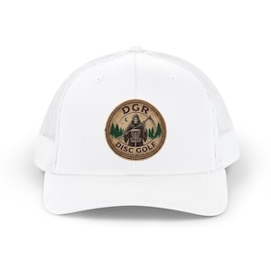 May include: A white trucker hat featuring a circular patch on the front. The patch displays a graphic of a grim reaper holding a scythe next to a disc golf basket, with pine trees, a crescent moon, and the text DGR DISC GOLF EST. 2024.