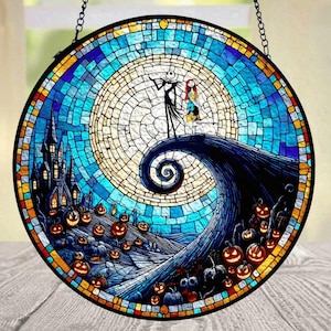 May include: A circular stained glass suncatcher featuring a mosaic pattern of a tall, thin skeleton figure and a female figure standing on a spiraling hill. The scene includes a dark castle, numerous glowing orange jack-o'-lanterns, and a large moon.