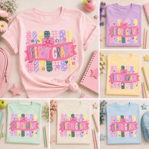 May include: A collection of six short-sleeved t-shirts in various pastel colors, each featuring a graphic print of vertical brushstrokes, a pink bow, and a banner with the text First Grade, Second Grade, Third Grade, Fourth Grade, Fifth Grade, or Sixth Grade.