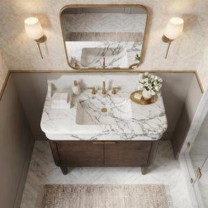 Top view of a handcrafted Calacatta marble bathroom vanity with an integrated sink, striking gray veining, brushed brass faucet, dark oak cabinet, spacious countertop, and premium natural stone. Luxury custom vanity for modern and transitional bathrooms.