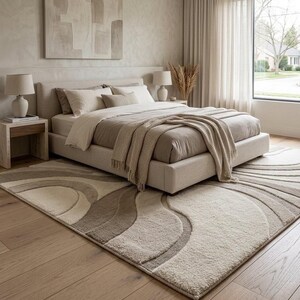 Modern cream and beige abstract wave area rug styled in a calm contemporary bedroom with neutral bedding, natural wood furniture, soft textiles and minimalist Japandi-inspired décor.