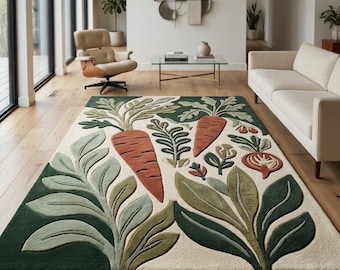 Puede incluir: Una alfombra rectangular con un diseño de mechones de zanahorias naranjas y follaje verde sobre un fondo color crema. La alfombra muestra una textura de relieve con acentos en verde oscuro, salvia y terracota en todo el patrón.