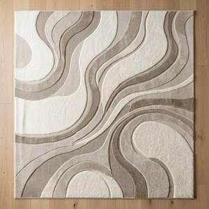 Full top view of a rectangular cream and beige abstract wave area rug showing the complete flowing organic composition, layered curved shapes, neutral color palette and sculpted dimensional surface.