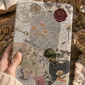 May include: A rectangular e-reader cover featuring a collage of vintage-style paper scraps, botanical illustrations, and script text. The design includes a dark red wax seal, black and white butterfly motifs, and floral accents in muted tones.