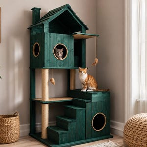 May include: A dark green wooden cat tree shaped like a house with a gabled roof, a chimney, and multiple levels. It features circular cutouts, sisal-wrapped scratching posts, a set of stairs, and hanging toys. Two cats are positioned on the structure.