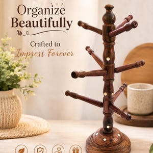 May include: A dark brown wooden mug tree stand with a central post and multiple extending branches for hanging items. The stand features a round base and small circular brass-colored inlays. Text on the image reads: Organize Beautifully.
