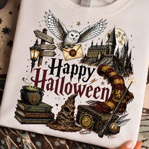 May include: A white crewneck sweatshirt featuring a graphic print with the text Happy Halloween. The design includes a snowy owl, a castle, a stack of books, a cauldron, a striped scarf, a sorting hat, a wand, and directional signs.