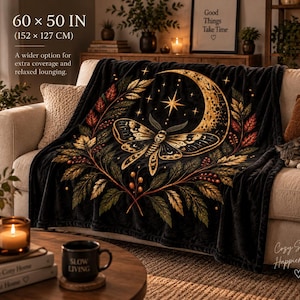May include: A black throw blanket featuring a gold crescent moon, a central moth, and surrounding autumn-toned foliage. The blanket measures 60 x 50 inches. The design includes stars and botanical elements printed on a soft, dark fabric surface.