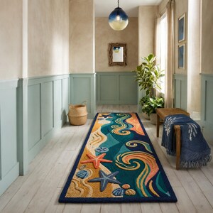 May include: A long rectangular runner rug featuring a coastal theme with raised textures of orange and blue starfish, seashells, and sand dollars set against a deep blue background with swirling wave patterns in shades of teal, yellow, and peach.