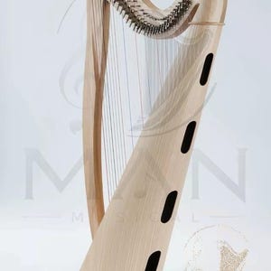 May include: A light-colored wooden harp featuring a curved neck, a series of vertical strings, and a soundboard with four oval-shaped sound holes. The instrument has metallic tuning pins along the top and rests on a stable, flat base.