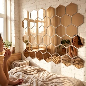 May include: A large wall-mounted decorative mirror set composed of multiple individual hexagonal mirror tiles arranged in a honeycomb pattern, creating a reflective surface that displays the surrounding room and light.