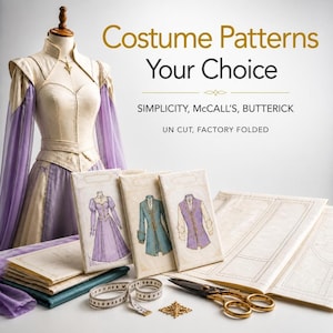 May include: A dress form displays a cream and lavender gown with sheer sleeves. Three sewing pattern envelopes labeled Simplicity, McCall's, and Butterick are arranged with a measuring tape, scissors, and unfolded pattern paper sheets.