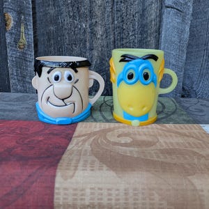 Set of 2 Vintage Flintstones Fred and Dino Flintstones Vitamins Advertising Cups