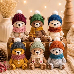 May include: Six crocheted teddy bears arranged in two rows. Each bear wears a knitted hat with a white pom-pom and a matching scarf. The bears feature various colours including burgundy, green, blue, yellow, sage, and orange, with small buttons.