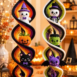 May include: Two hanging crochet spiral decorations featuring Halloween characters. The left spiral is orange, purple, and black, holding a ghost, pumpkin, and black cat. The right spiral is green, purple, and white, holding a skeleton, monster, and bat.