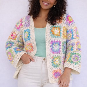 May include: A crochet cardigan featuring a cream-colored base with a multi-colored granny square pattern in shades of pink, yellow, blue, green, and purple. The garment has an open front, long sleeves, and a textured, hand-stitched appearance.