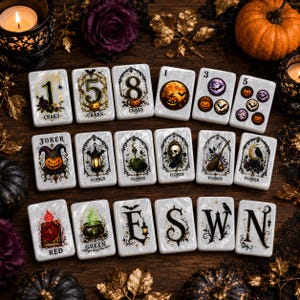 May include: A set of rectangular mahjong tiles featuring Halloween-themed illustrations. The tiles display numbers, flowers, and directional letters E, S, W, N, alongside imagery of pumpkins, skulls, bats, lanterns, spellbooks, and cauldrons.