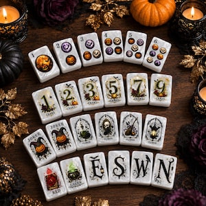 May include: A set of white rectangular mahjong tiles featuring Halloween-themed illustrations. The tiles display numbers one through six, craks, jokers, flower symbols, green, red, and the letters E, S, W, and N, all decorated with pumpkins, bats, and skulls.