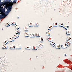 May include: A collection of white rectangular mahjong tiles arranged to form the number 250. Each tile features colorful patriotic graphics including American flags, eagles, fireworks, and lighthouses, set against a background with firework motifs.