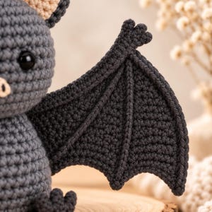 Halloween crochet bat plush toy with soft grey body and peach inner ears