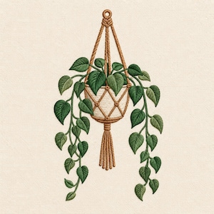 May include: An embroidery design featuring a potted plant in a tan macrame hanger. The plant has dark and light green heart-shaped leaves cascading down both sides. The pot is white with a diamond-patterned cord overlay and a tassel at the base.