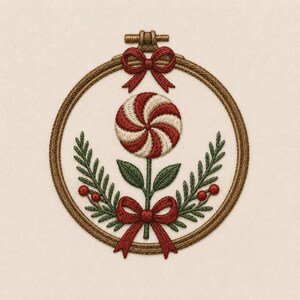 May include: A circular wooden embroidery hoop framing a fabric piece with a stitched design. The embroidery features a red and white swirled peppermint candy on a stem, flanked by green fern-like leaves and red berries, with red bows at the top and bottom.