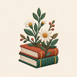 May include: An embroidery design featuring a stack of two books, one orange and one green, with white daisy flowers, green leaves, and small red berries growing upward from the top book. The stitching is detailed with visible thread textures.