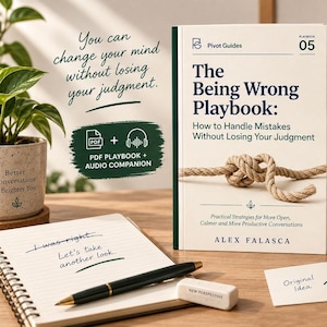 May include: A book titled The Being Wrong Playbook by Alex Falasca with a rope knot on the cover. The book is surrounded by a spiral notebook, a black pen, a white eraser, a ceramic mug, and a stack of small cards on a wooden desk surface.
