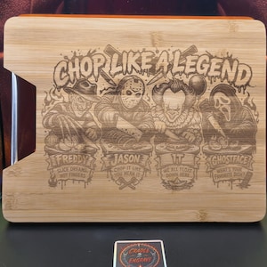May include: A rectangular bamboo cutting board featuring a laser-engraved design with the text CHOP LIKE A LEGEND. The illustration depicts four horror movie characters, Freddy, Jason, IT, and Ghostface, each with their own specific quote.
