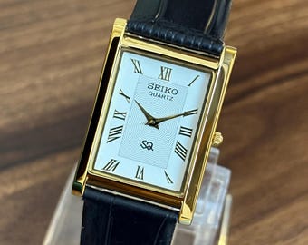 Vintage Seiko White Dial Gold Tone Tank Watch Black Leather Strap Quartz