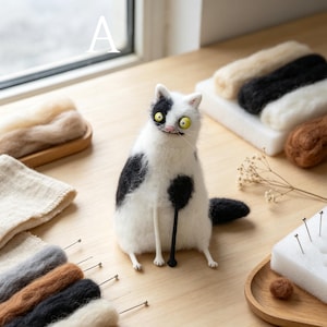 May include: A needle-felted white cat figurine with black patches, large yellow eyes, and a pink nose. The cat holds a thin black rod. Surrounding the cat are various colored wool roving bundles, a white foam block, and metal needles.