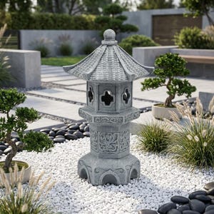 May include: A gray stone garden lantern featuring a hexagonal base, a central section with intricate relief carvings, and a tiered roof with a small spherical finial. The structure includes open cutouts in a cross shape on each side panel.