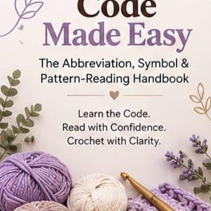 May include: A book cover titled Crochet Code Made Easy: The Abbreviation, Symbol & Pattern-Reading Handbook by Isha Crochet Studio. The cover features purple and cream yarn balls, a gold crochet hook, and a crocheted swatch with floral accents.