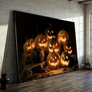 May include: A large rectangular wall art print featuring a dark, atmospheric scene of multiple carved pumpkins with glowing, jagged-cut faces. The pumpkins are arranged on a textured, earthy surface against a deep black background.