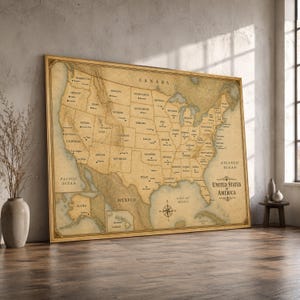 May include: A large rectangular wall map of the United States of America with a vintage parchment aesthetic. The map displays state boundaries, major cities, and geographical features in black ink on a tan background, including a compass rose.