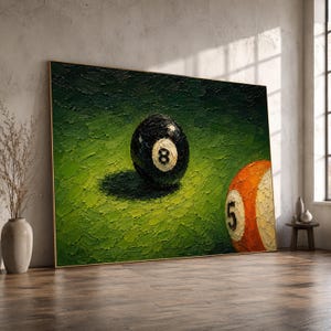 May include: A rectangular wall art piece featuring an oil painting with thick, textured brushstrokes. The artwork depicts a black eight ball and an orange five ball resting on a vibrant green surface, creating a bold contrast of colours.