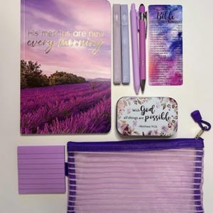 May include: A purple-themed stationery set including a notebook with a lavender field cover and the text His mercies are new every morning, two highlighters, two pens, a Bible emergency numbers card, a small tin, a notepad, and a mesh pouch.