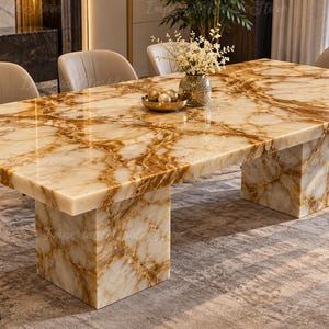 May include: A rectangular dining table featuring a polished cream and amber-toned onyx stone surface with prominent golden-brown veining. The table is supported by two thick, matching rectangular stone pedestal bases and surrounded by six beige chairs.