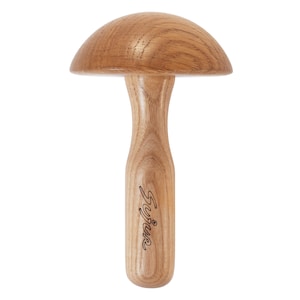 May include: A light brown wooden darning mushroom with a smooth, polished finish and visible wood grain. The stem features the word Syice engraved in a cursive script. The object has a rounded cap and a cylindrical handle for easy gripping.