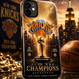 May include: A black phone case featuring a gold and orange New York Knicks logo, a championship trophy, and the text 2026 NBA CHAMPIONS, NEW YORK FOREVER, KNICKS FOREVER, and ONCE A KNICK, ALWAYS A CHAMPION against a backdrop of a city skyline.