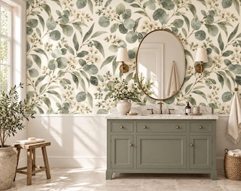 May include: A bathroom vanity with a sage green cabinet, marble countertop, and oval mirror. The wall features wallpaper with a botanical pattern of green eucalyptus leaves and small white flowers. Two wall sconces flank the mirror.