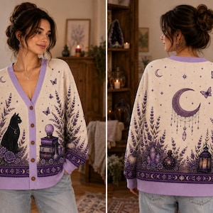 May include: A cream-coloured V-neck cardigan featuring a purple lavender print, a black cat, and a stack of books on the front. The back displays a large purple crescent moon, butterflies, crystals, a potion bottle, and a lantern, all with purple trim.