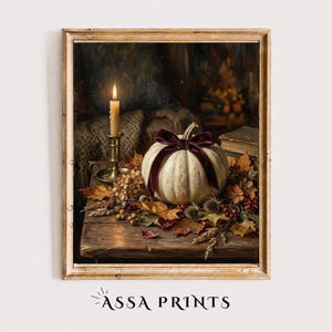 May include: A framed oil painting depicting a white pumpkin adorned with a dark burgundy velvet ribbon, resting on a wooden table surrounded by dried autumn leaves, wheat stalks, and berries, with a lit candle in a brass holder nearby.