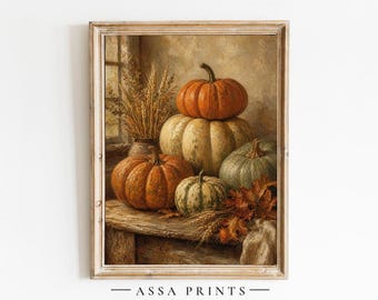 May include: A framed oil painting print featuring a still life of four pumpkins in shades of orange, cream, and sage green arranged on a wooden surface with dried wheat stalks and autumn leaves. The text ASSA PRINTS is printed below the frame.
