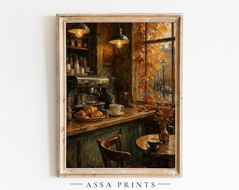May include: An oil painting print featuring a cozy cafe interior with a dark wooden counter, an espresso machine, a basket of croissants, and a small round table with a coffee cup. A window reveals autumn foliage and the text ASSA PRINTS.