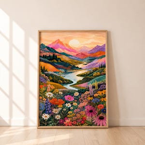 May include: A rectangular framed wall art print featuring a vibrant landscape painting. The scene depicts a winding river flowing through colorful rolling hills and mountains under a soft sunset sky, with a dense foreground of wildflowers.