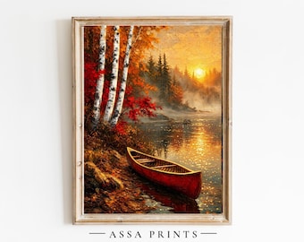 May include: A framed landscape painting depicting a red canoe resting on the shore of a lake at sunset. The scene features white birch trees with orange and red autumn foliage, a golden sun on the horizon, and the text ASSA PRINTS at the bottom.