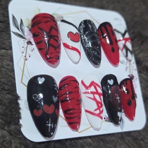 Stray Kids handmade press on nails size Medium. Medium length oval nails. Black, red and white nails with KPop Stray Kids inspired designs.