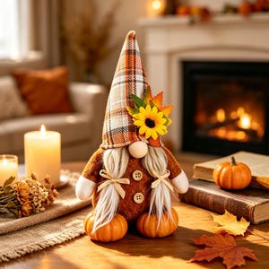 May include: A decorative gnome figurine featuring a tall orange and white plaid hat adorned with a yellow sunflower and autumn leaves. The gnome has a round nose, long light-colored hair tied with ribbons, and a brown body with two wooden buttons.